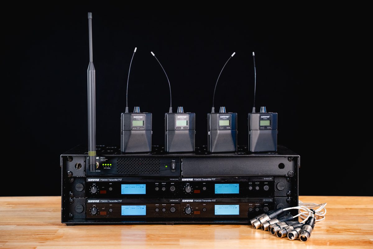 Rack of Shure PSM300 P3T transmitters with P3RA receiver packs